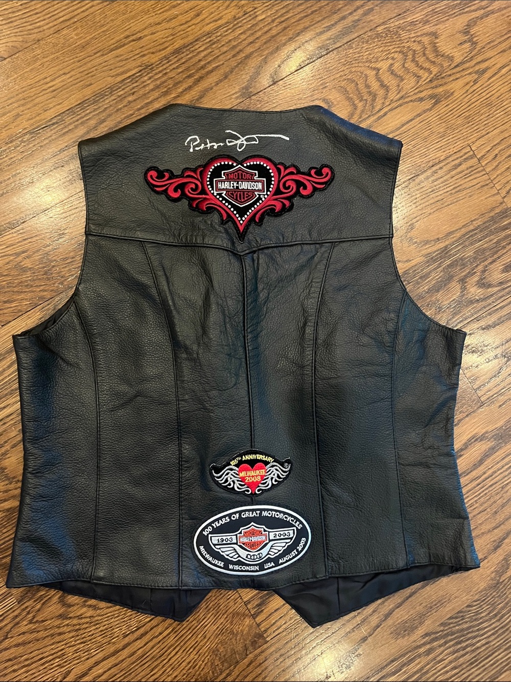 pre-patched black leather motorcycle vest features an embroidered Harley M